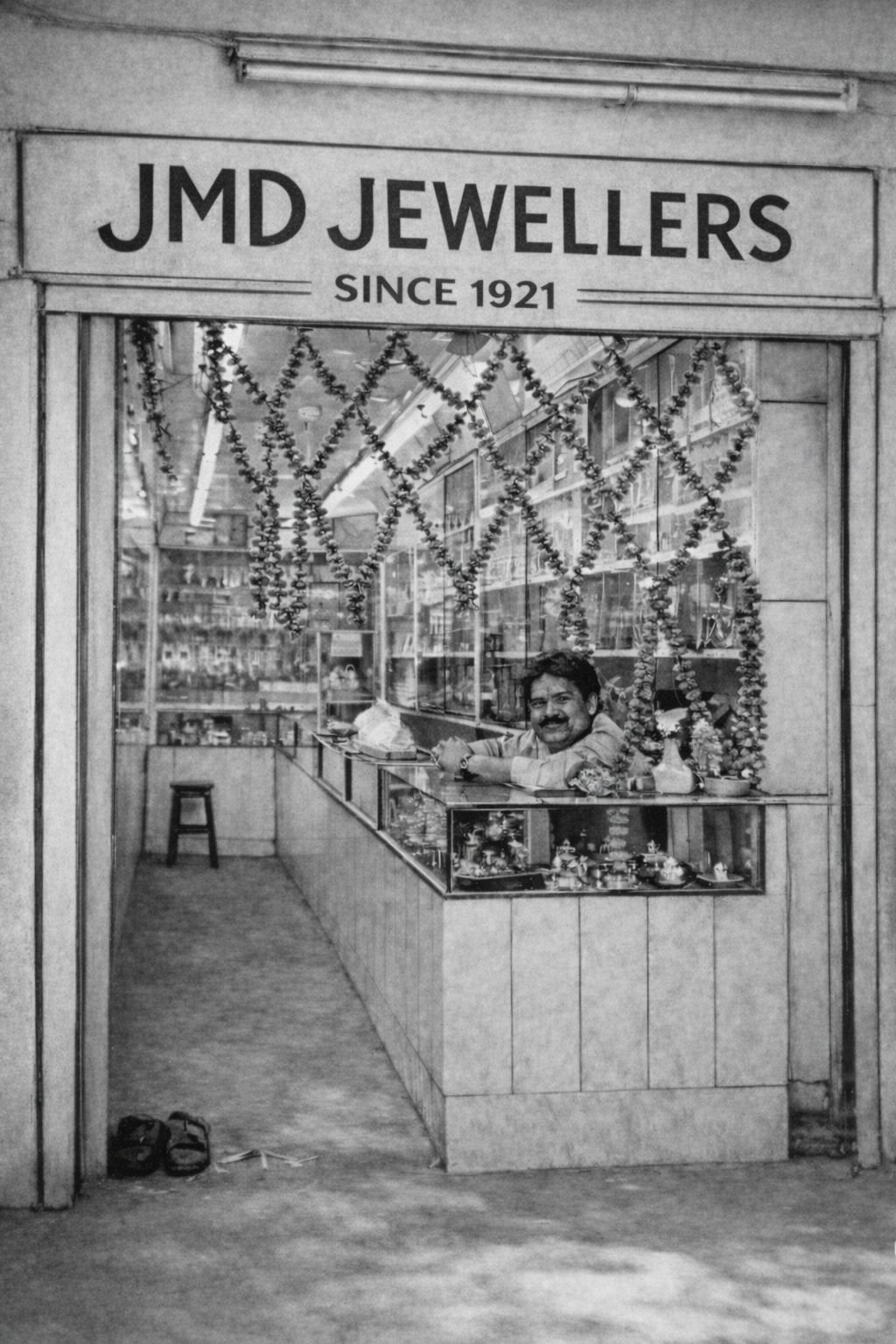 The original JMD Jewellers shop since 1921 - Founder at the counter with festive garland decorations